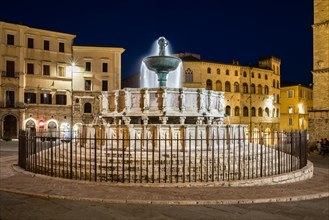 Illuminated medieval fountain Fontana Maggiore at night