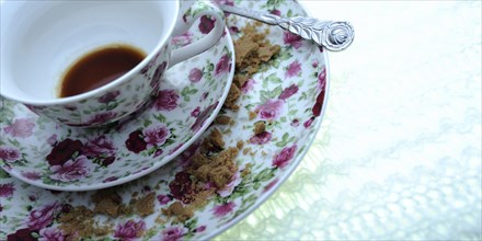 Used coffee cup with a floral pattern
