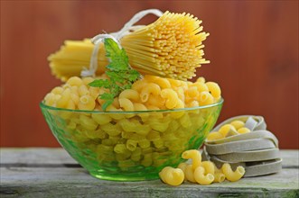 Various types of pasta with a glass bowl