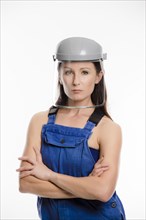 Woman wearing blue overalls and a protective helmet