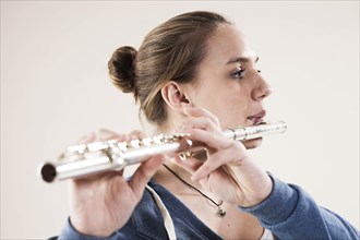 Teenage girl playing the flute