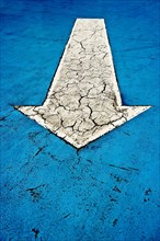 White arrow on blue asphalt