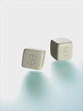 Two dice with currency symbols
