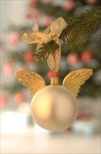 Silver bauble with golden angel wings