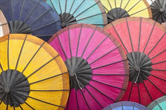 Multicoloured hand-made paper umbrellas or parasols on display at a market in Luang Prabang