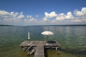 Lake Starnberg with bathing jetty and parasol