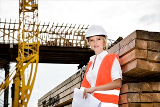 A young female constructor at building of a new motorway