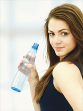 Young woman holding a bottle of water