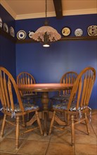 Antique table and chairs in the kitchen of a 1998 reproduction of an old Canadiana cottage style residential Home