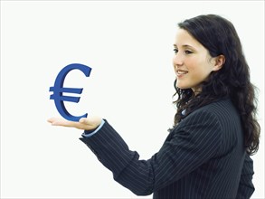Young businesswoman holding an euro sign