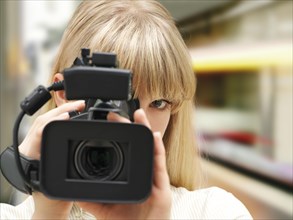 Woman filming with a video camera