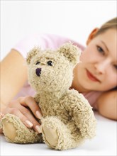 Young woman with a teddy bear