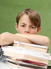Schoolboy with a stack of books