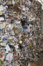 Stacked bales of recyclable cardboard and paper at a sorting centre