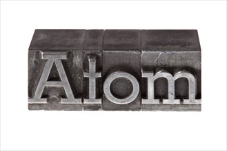 Old lead letters forming the word 'Atom'