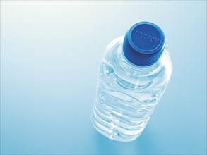 Plastic bottle filled with water with the word water on the lid