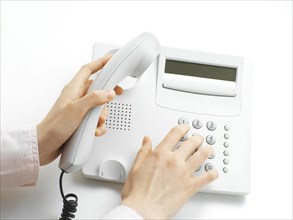 Woman making a call on a telephone