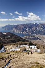 Hikers on their way to Monte Stivo mountain above St. Barbara on Lake Garda