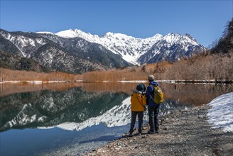 Two Japanese tourists at a lake