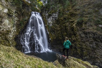 Woman standing in front of Bandokoro Waterfall