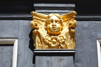 Golden putto at the portal of the St. Nicholas Church