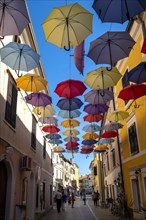 Colorful umbrellas over a road