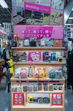 Instant cameras for sale at an electronics store
