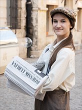 Historically dressed newspaper saleswoman