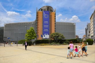 Children walking in front of the Berlaymont building is the seat of the European Commission