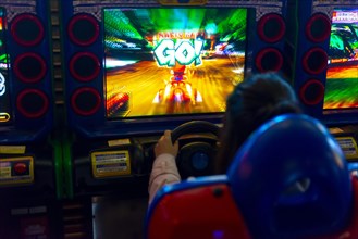 Teenager plays a car racing game