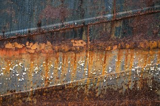 Rusty hull with barnacles