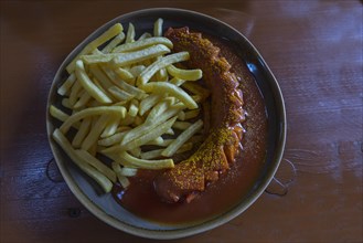 Currywurst with French fries on a plate