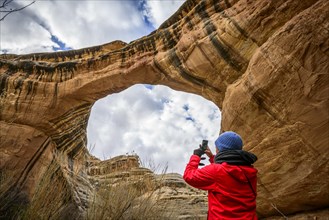 Tourist photographs rock arch