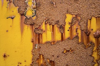 Rust on yellow metal wall