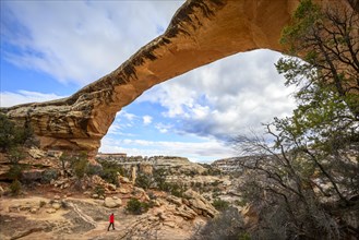 Tourist under rock arch
