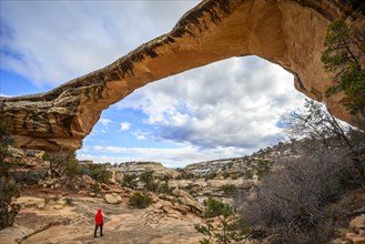 Tourist under rock arch