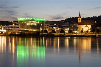 Danube bank with Ars Electronica Center at dusk