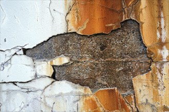 Plaster chipped off on a house wall