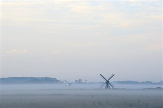 Small windmill with ground fog