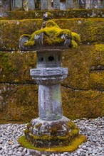 Moss-covered stone candelabra