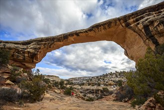 Tourist under rock arch