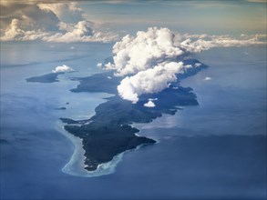 Aerial view south point island Selayar with fringing reef and clouds
