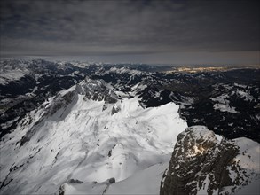 View from Santis to snow-covered mountain landscape at full moon