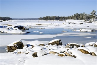 Snow-covered lake landscape in sunshine