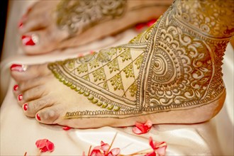 Close up of mehendi on foot of a bride