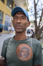 Cuban with tattooed portrait of Che Guevara