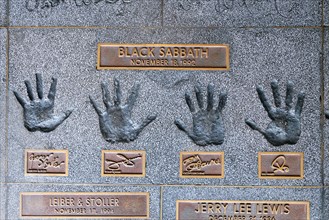 Hands of the band Black Sabbath with Geezer ButlerTony Iommi