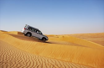 Off-road vehicle drives in the sand dunes