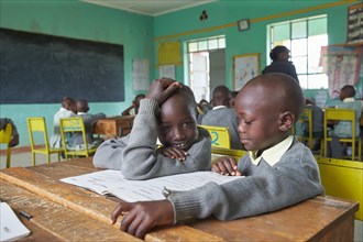 Schoolgirl and schoolgirl in the classroom during lessons at the Primary School