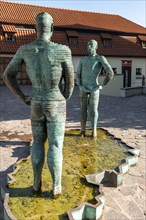 Two male figures peeing